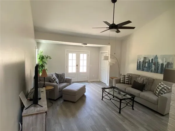 a living room with furniture and a wooden floor