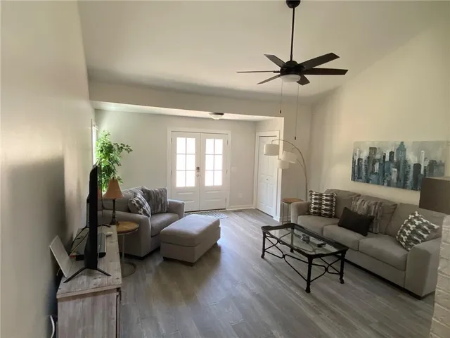 a living room with furniture and a wooden floor