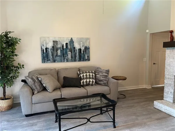 a living room with furniture and a potted plant