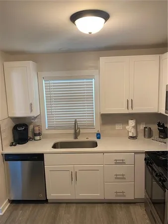a kitchen with stainless steel appliances a refrigerator and a stove top oven