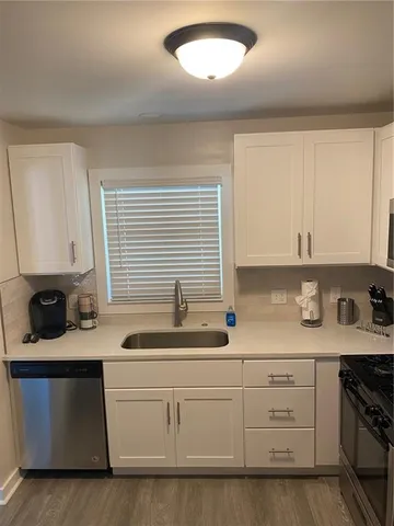 a kitchen with stainless steel appliances a refrigerator and a stove top oven