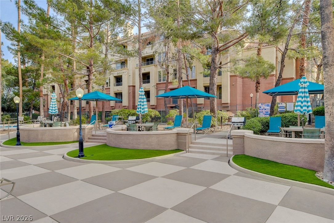 230 East Flamingo Road, Unit 106 Las Vegas, NV 89169 - Photo 47 of 66 Lush landscaping and ample seating invite relaxation and al fresco dining in this vibrant community space.