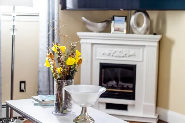 a view of living room with furniture and a fireplace