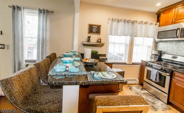 a kitchen with sink stove and refrigerator