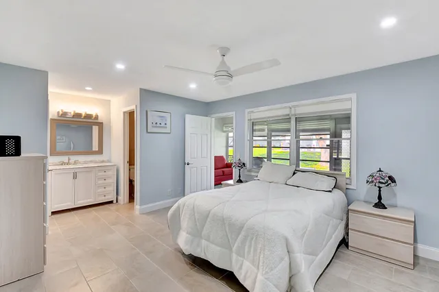 a bedroom with a large bed closet and a window