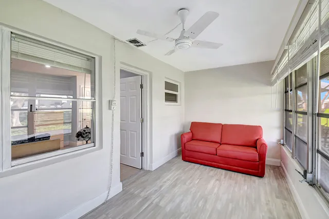 a view of a porch with furniture and floor to ceiling window