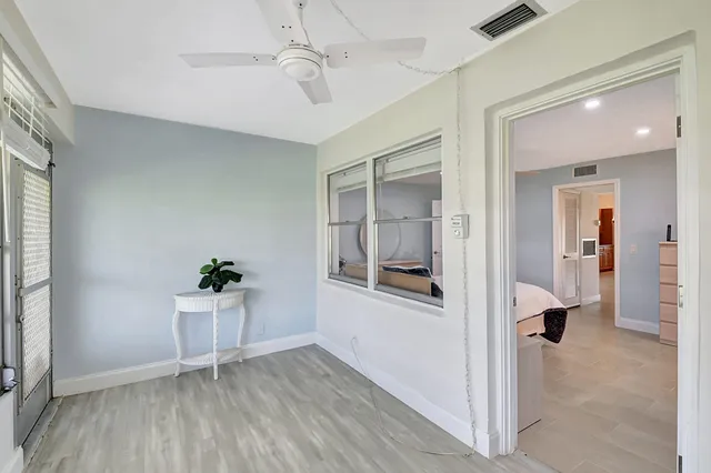 a front view of a house with a garden and seating space