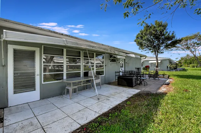 an aerial view of residential houses with outdoor space and pool