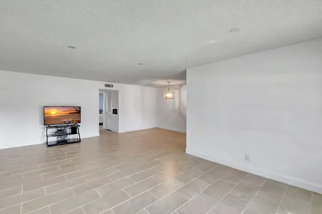 a view of empty room with furniture and window