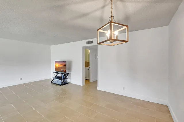 a view of a livingroom with a piano and wooden floor
