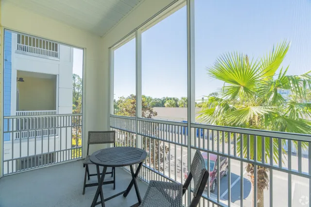 a view of a porch with a table and chairs