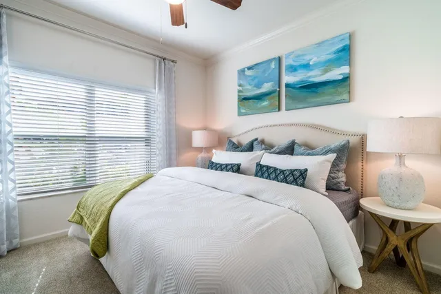 a bedroom with a bed and a painting on the wall