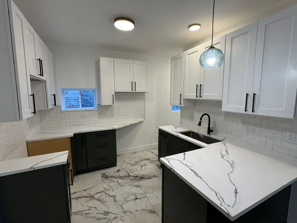 a kitchen with a sink a stove and cabinets