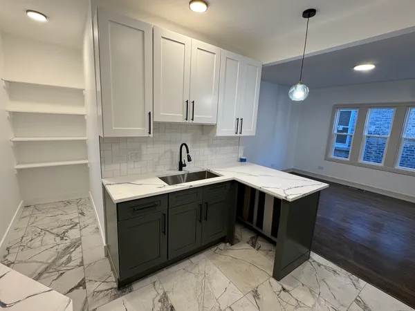 a kitchen with a sink cabinets and window