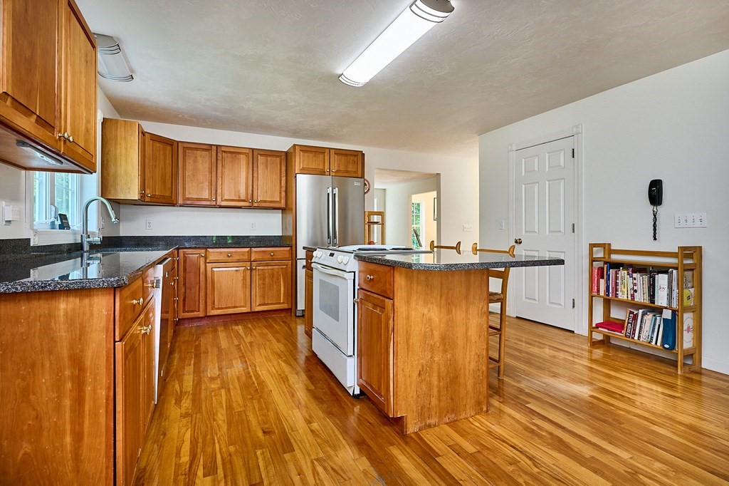 37 Shattuck Road Hadley, MA 01035 - Photo 8 of 42 a kitchen with stainless steel appliances granite countertop wooden cabinets a refrigerator and a sink