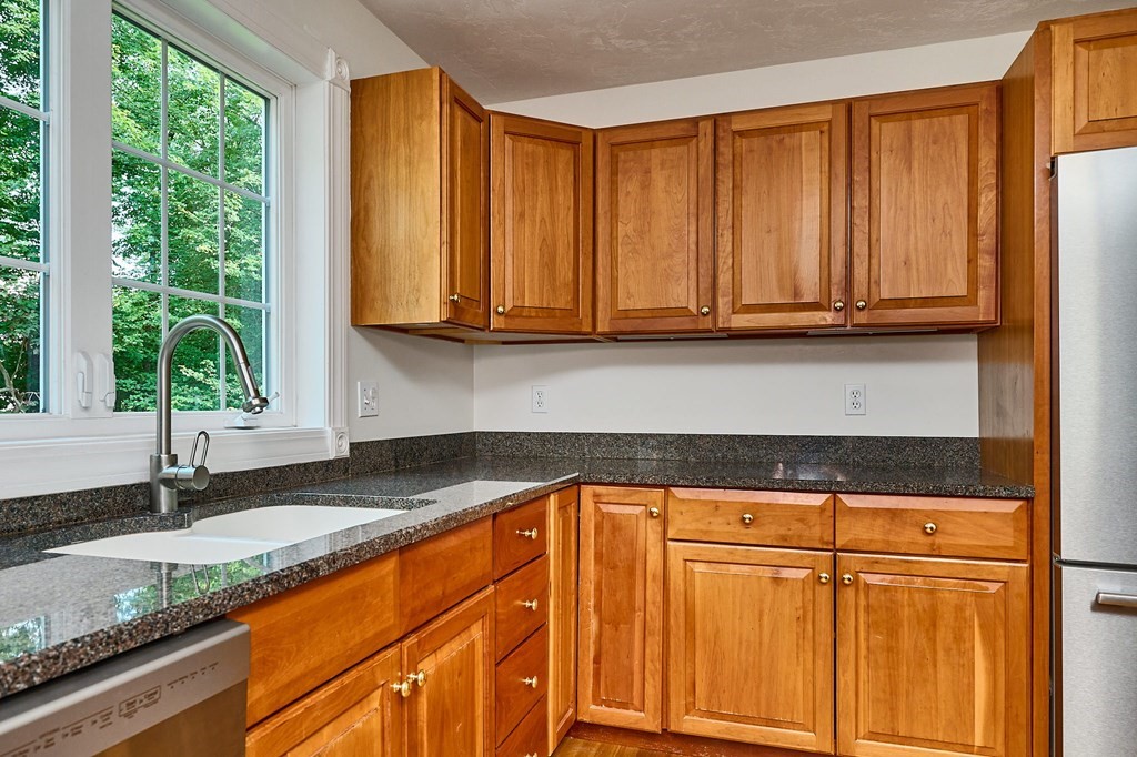 37 Shattuck Road Hadley, MA 01035 - Photo 9 of 42 a kitchen with granite countertop wooden cabinets a sink and a window