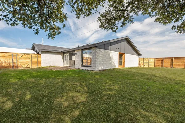 a view of a house with a backyard