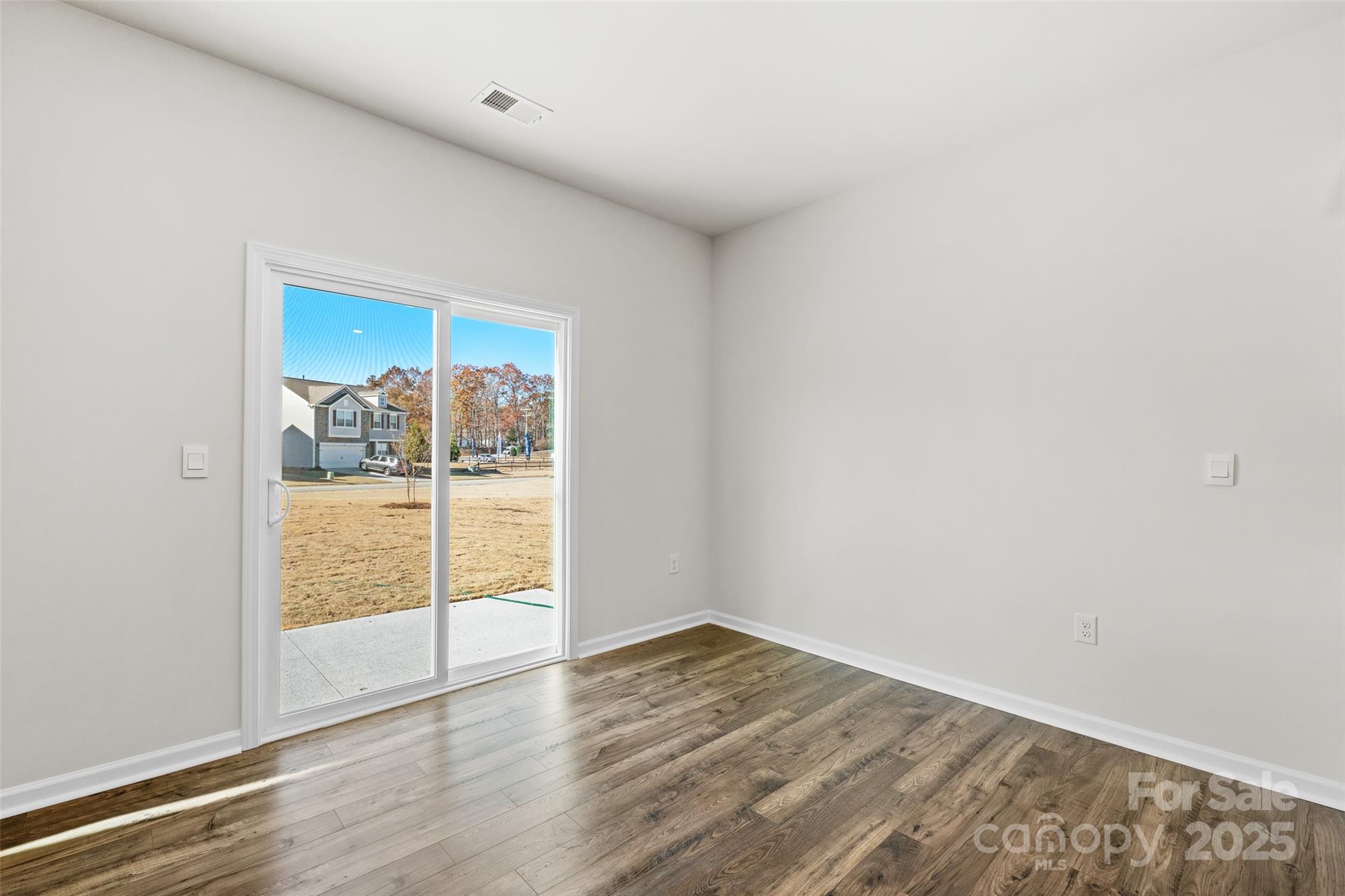 99 Bovine Br Road Fletcher, NC 28732 - Photo 11 of 29 an empty room with wooden floor and door