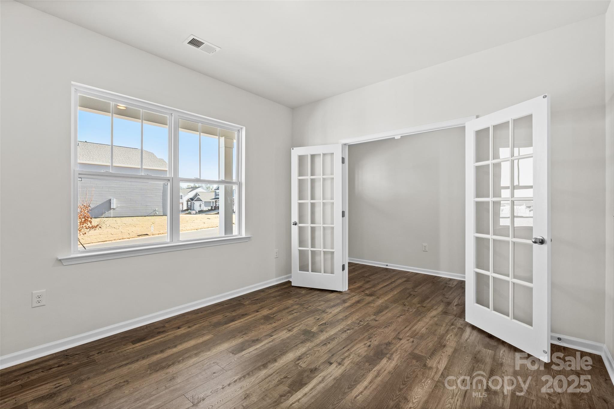 99 Bovine Br Road Fletcher, NC 28732 - Photo 13 of 29 an empty room with wooden floor and windows