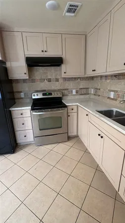 a kitchen with granite countertop cabinets and steel stainless steel appliances