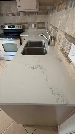 a kitchen with a sink and a stove