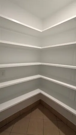 a refrigerator sitting in a bathroom with a bathtub