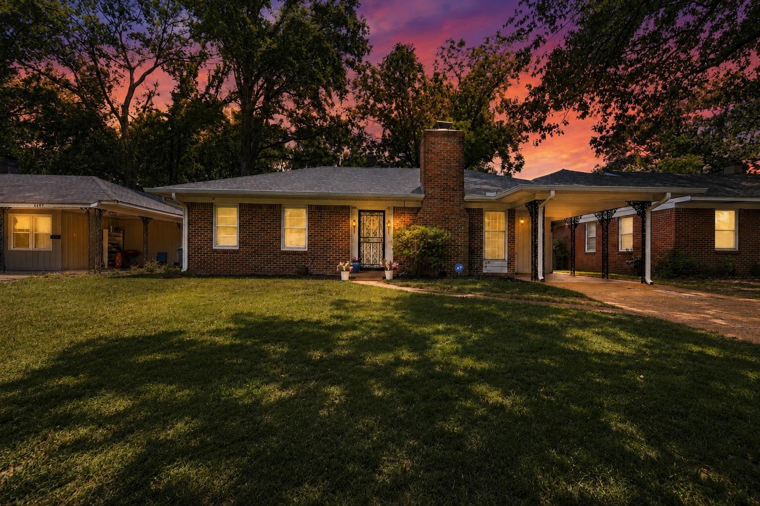 4491 Garnett Road Memphis, TN 38117 - Photo 1 of 32 Brick exterior home with a prominent brick chimney, front lawn, and an attached carport