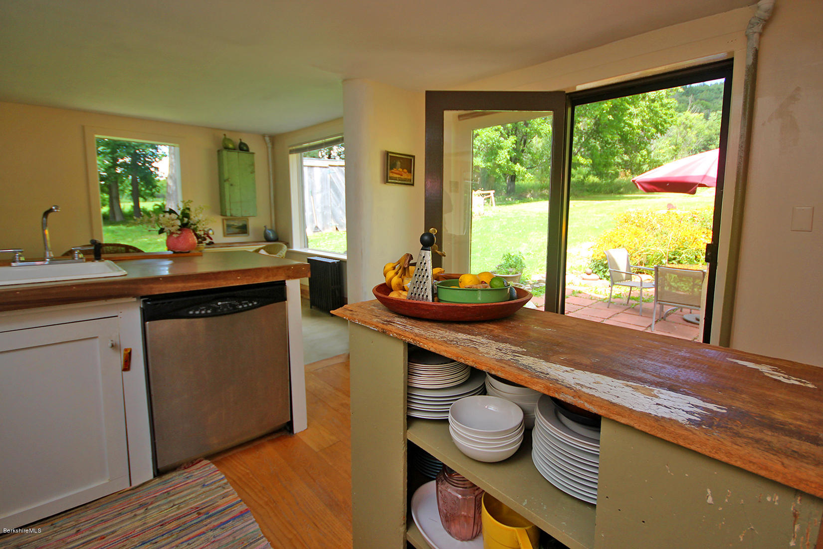 47 Main Road Tyringham, MA 01238 - Photo 14 of 31 a kitchen with a sink and wooden cabinets