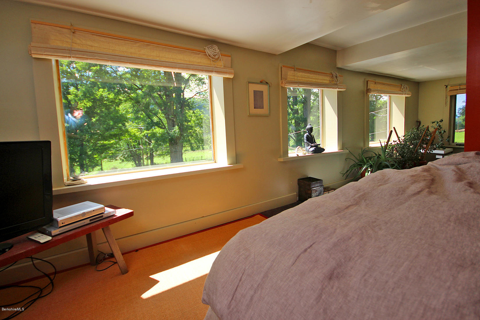 47 Main Road Tyringham, MA 01238 - Photo 18 of 31 a bedroom with a bed and large windows