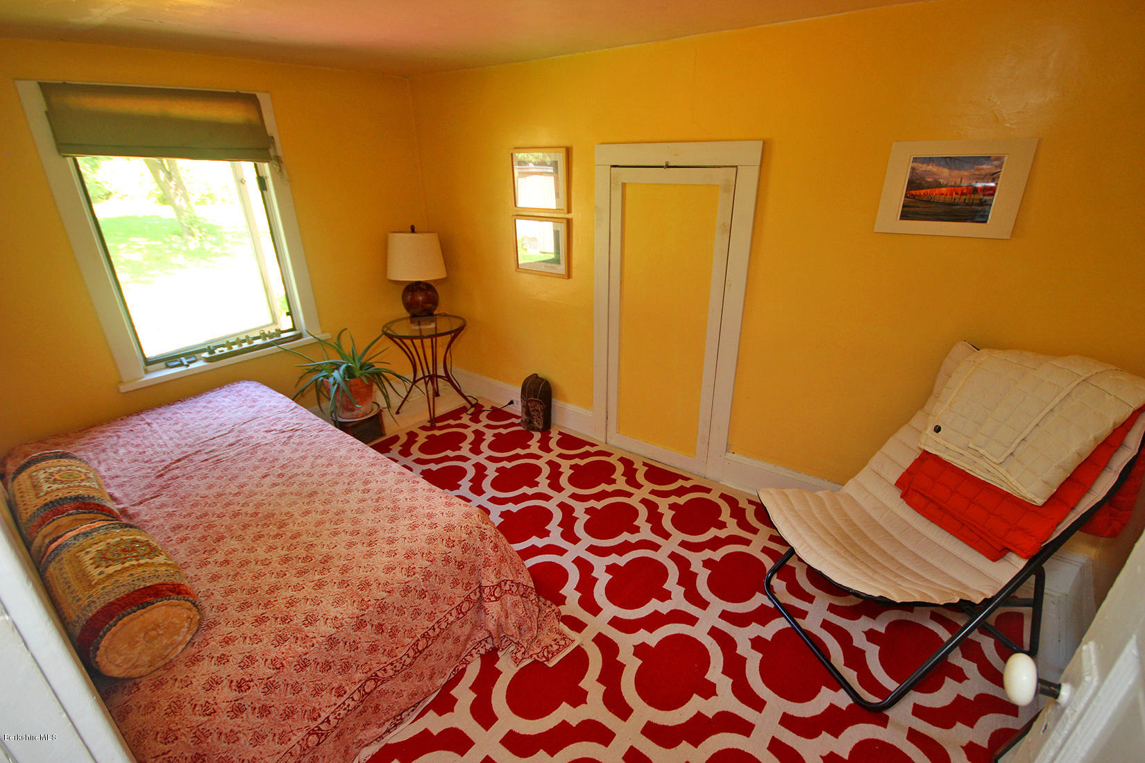 47 Main Road Tyringham, MA 01238 - Photo 22 of 31 a bedroom with a bed and wooden floor
