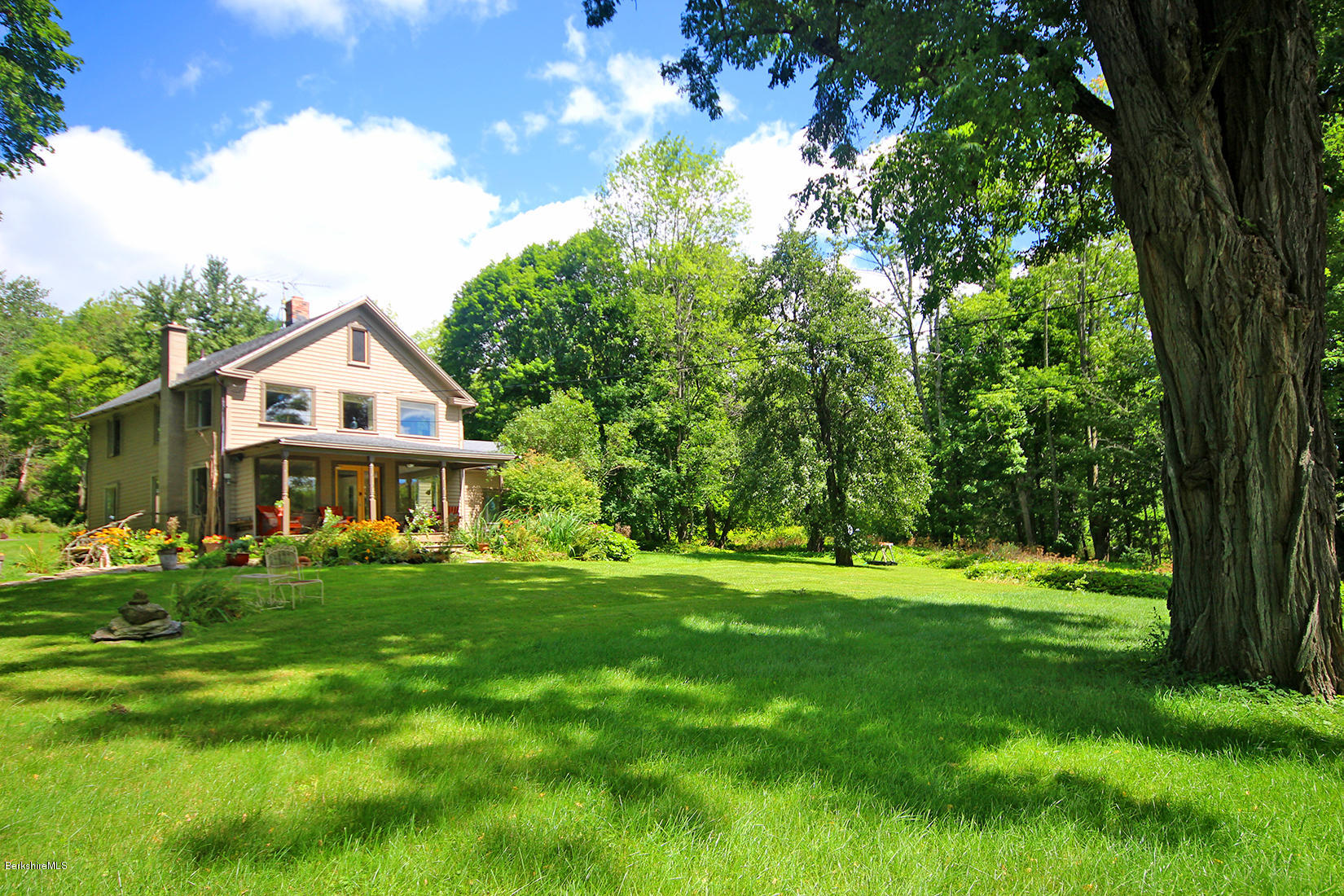 47 Main Road Tyringham, MA 01238 - Photo 25 of 31 a view of a big house with a big yard and large trees