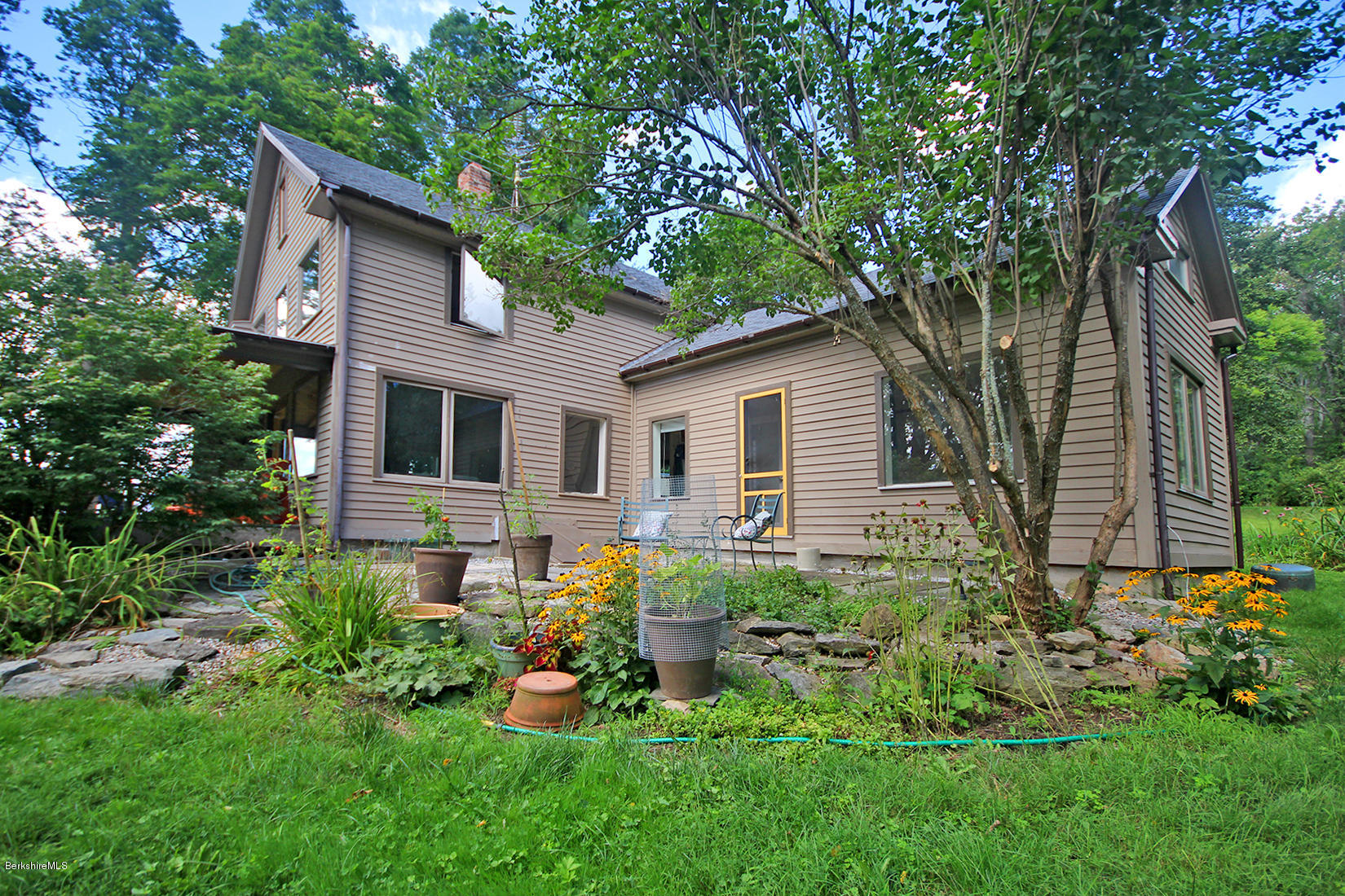 47 Main Road Tyringham, MA 01238 - Photo 26 of 31 a front view of house with a garden and patio