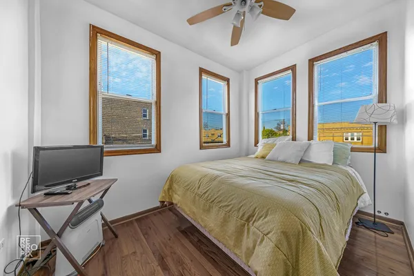 a bedroom with a bed and a desk