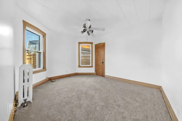 an empty room with windows and closet