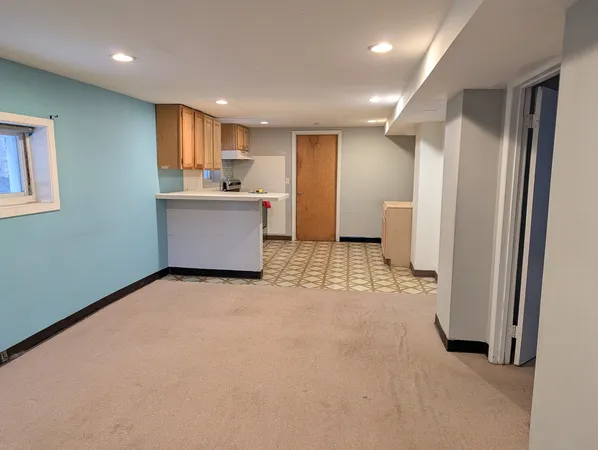 a view of a kitchen with a refrigerator and a sink
