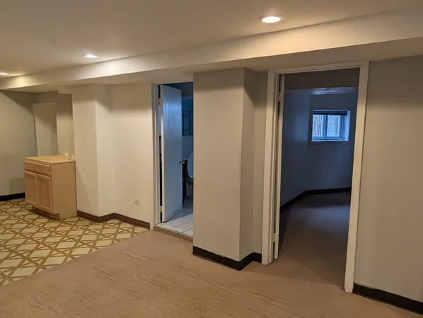 a view of a hallway with closet and wooden floor