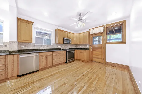 a kitchen with stainless steel appliances granite countertop a sink and cabinets