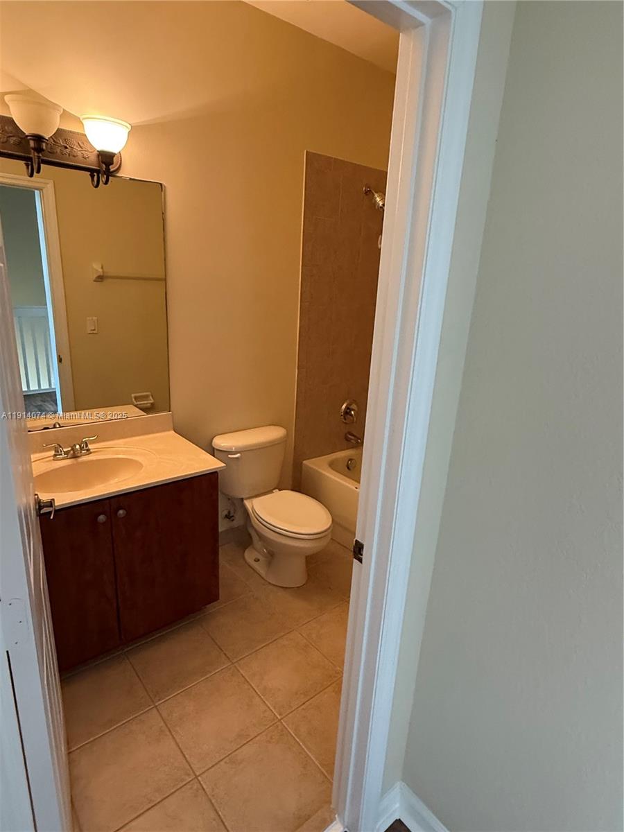 1713 Southwest Umbria Street, Unit 1713 Port St. Lucie, FL 34953 - Photo 12 of 17 a bathroom with a bathtub and sink