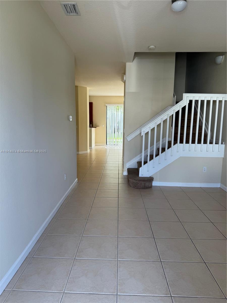 1713 Southwest Umbria Street, Unit 1713 Port St. Lucie, FL 34953 - Photo 2 of 17 a view of a hallway with entryway
