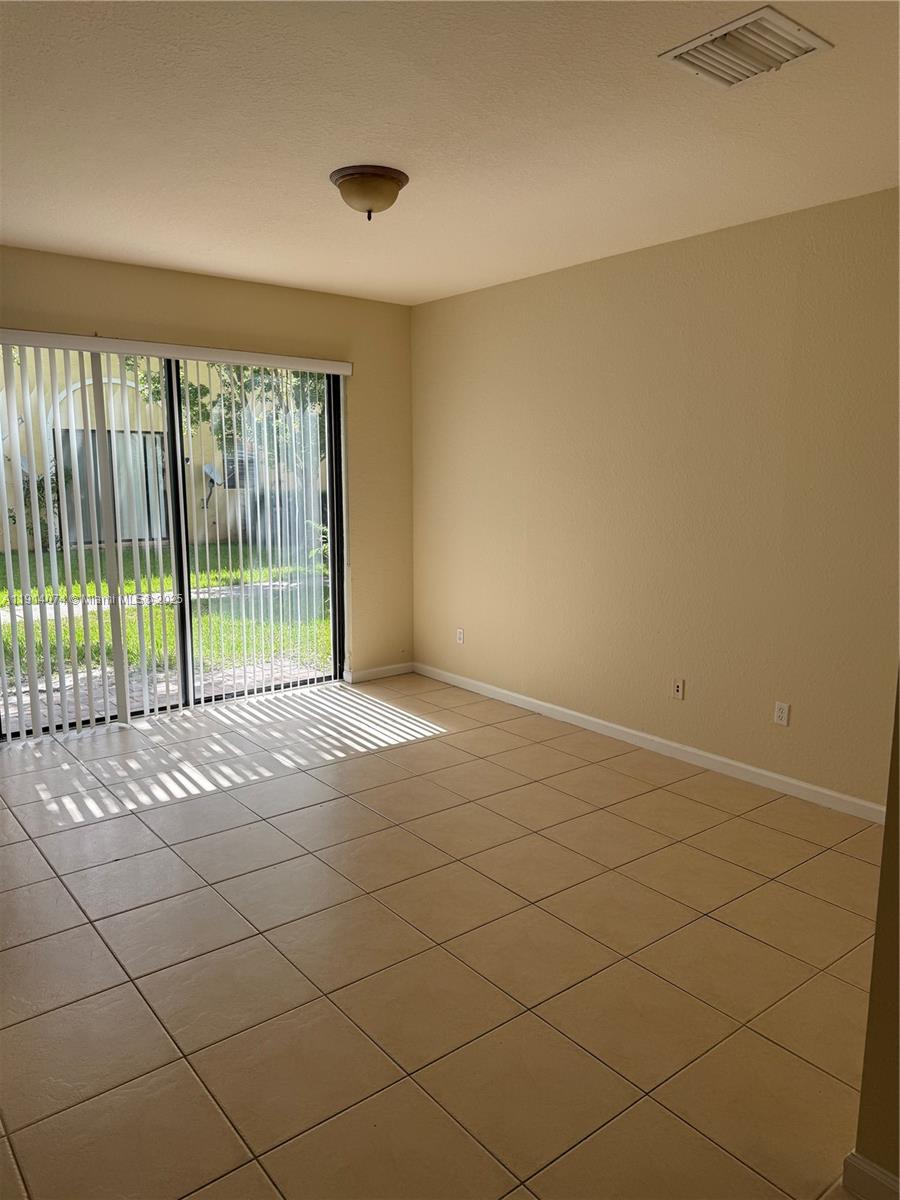 1713 Southwest Umbria Street, Unit 1713 Port St. Lucie, FL 34953 - Photo 7 of 17 a view of an empty room with a window