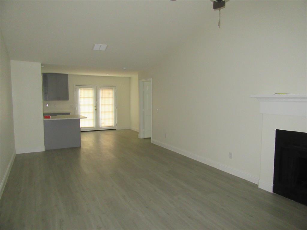 2209 Merrimac Lane Lancaster, TX 75146 - Photo 2 of 11 a view of an empty room with a window and wooden floor