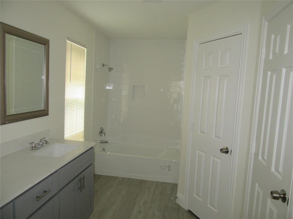 2209 Merrimac Lane Lancaster, TX 75146 - Photo 4 of 11 a bathroom with a sink and a mirror