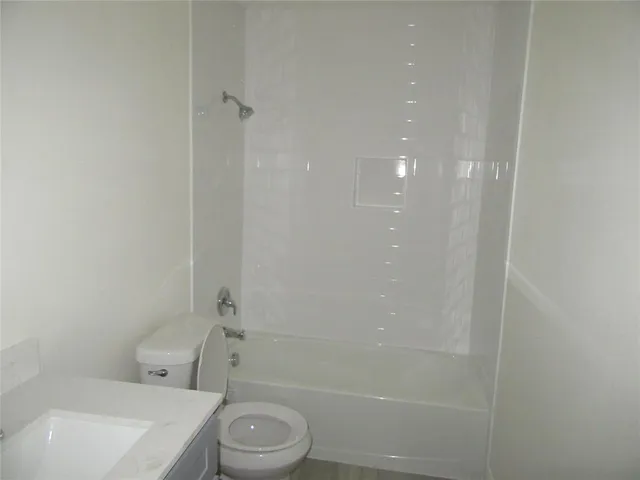 a bathroom with a toilet a sink and shower