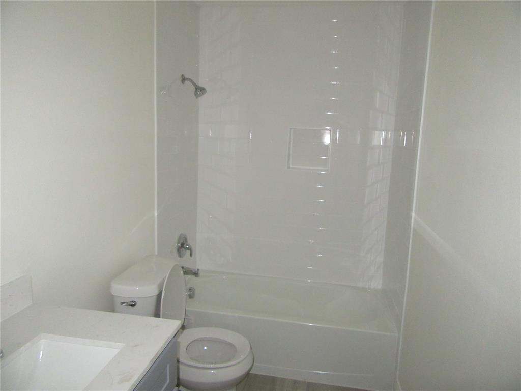 2209 Merrimac Lane Lancaster, TX 75146 - Photo 8 of 11 a bathroom with a toilet a sink and shower