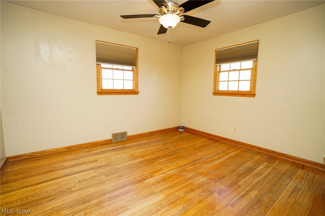 453 Omar Street Struthers, OH 44471 - Photo 21 of 27 Unfurnished room featuring wood finished floors and ceiling fan
