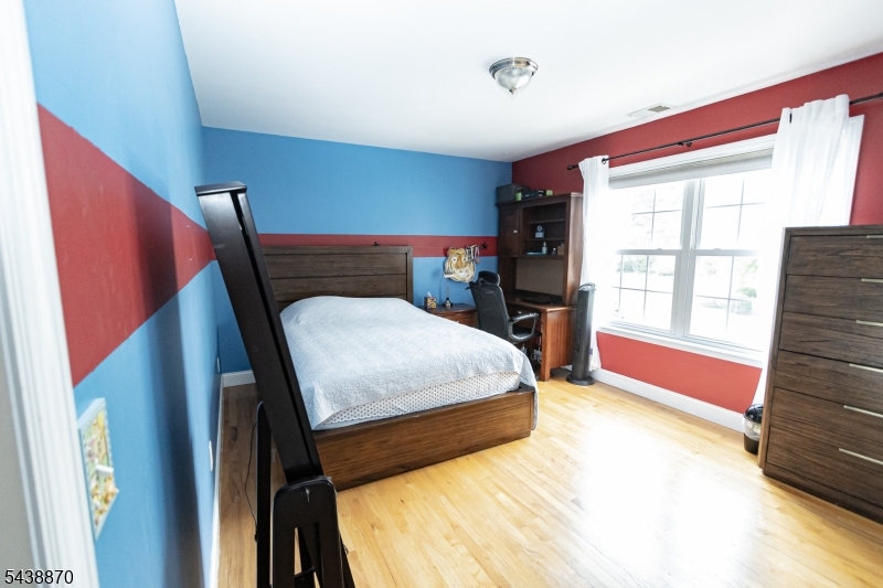 419 Putnam Road Union, NJ 07083 - Photo 22 of 37 a bedroom with a bed and wooden floor