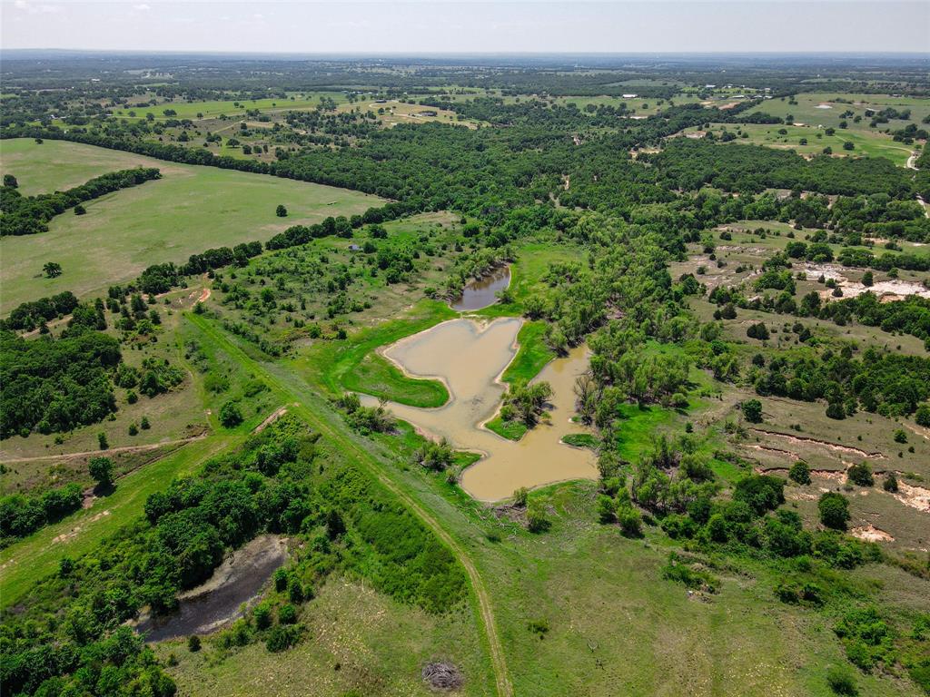 2043 Huddleston Road Sunset, TX 76270 - Photo 33 of 36 an aerial view of a houses with a lush green hillside