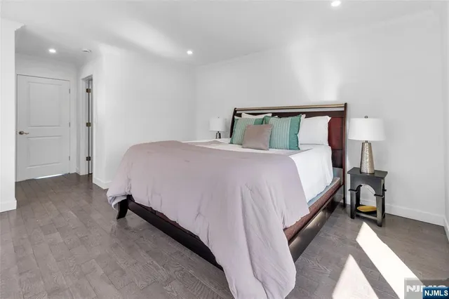 a bedroom with a bed and a night stand