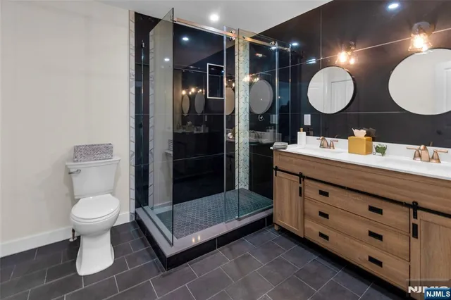 a bathroom with a toilet sink a mirror and shower