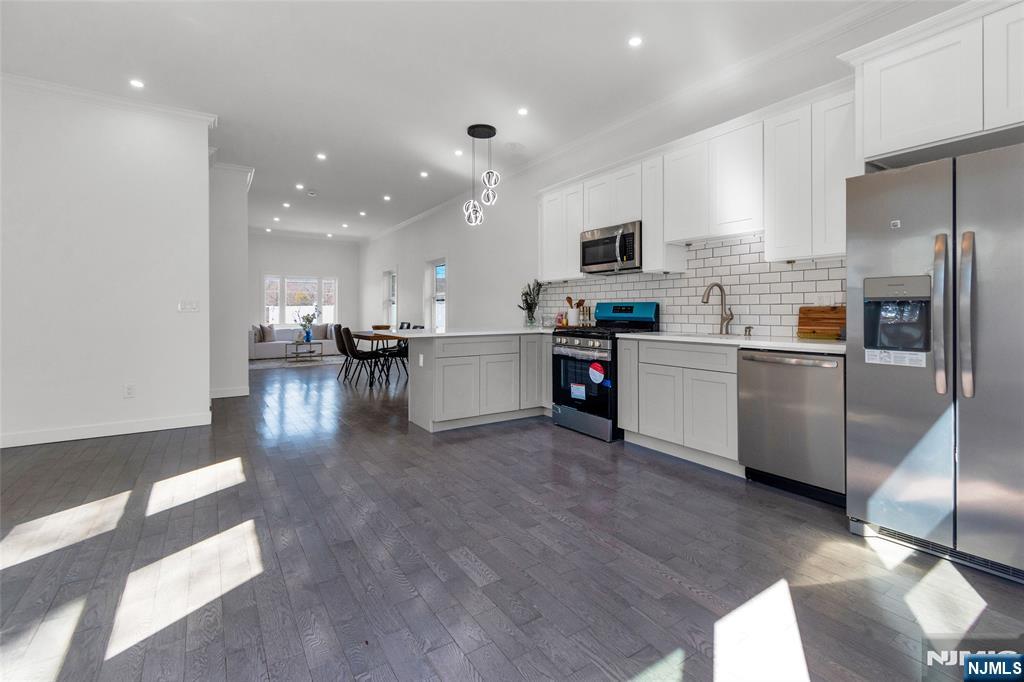 784 Valley Street Union, NJ 07088 - Photo 7 of 20 a kitchen with stainless steel appliances kitchen island granite countertop a sink and cabinets